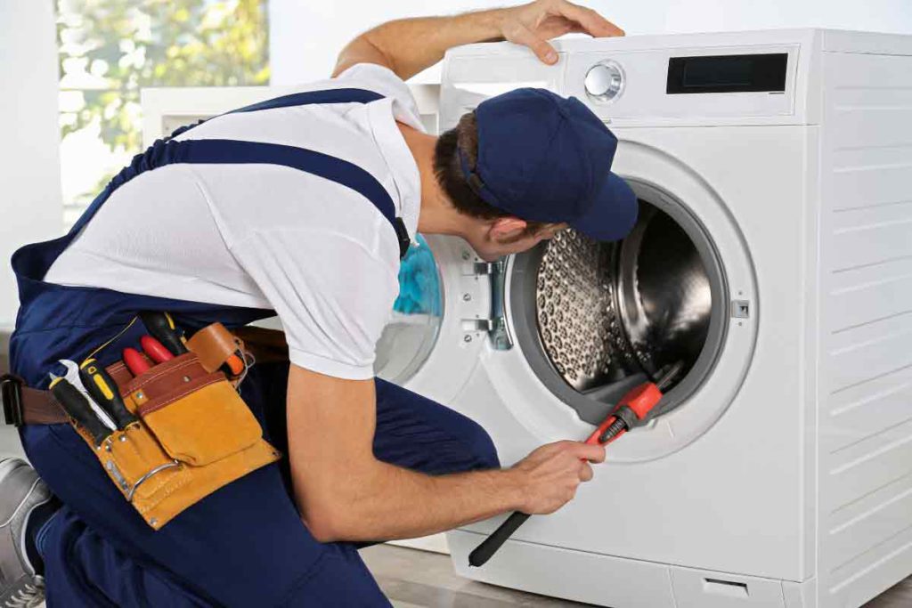 appliance repair professional working on washing machine